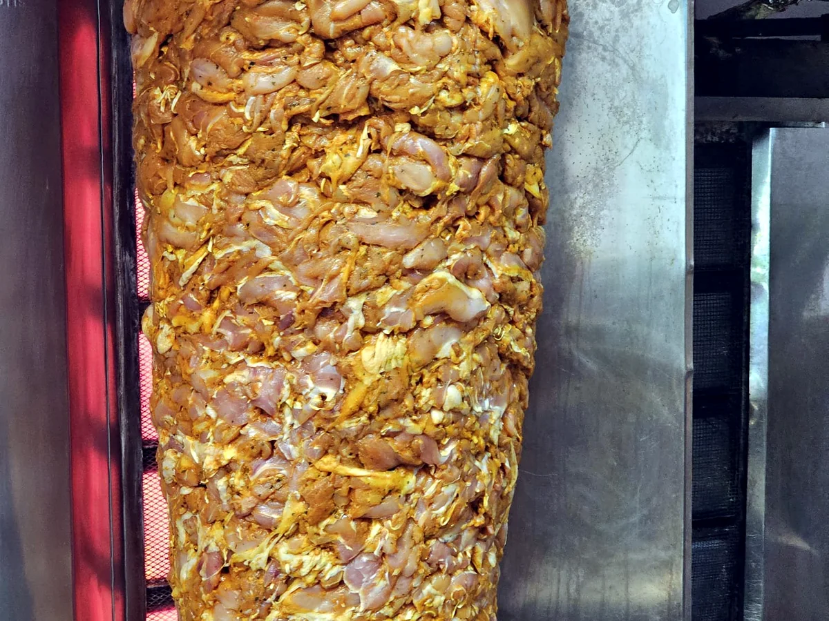 Close-up of layered meat on a vertical spit