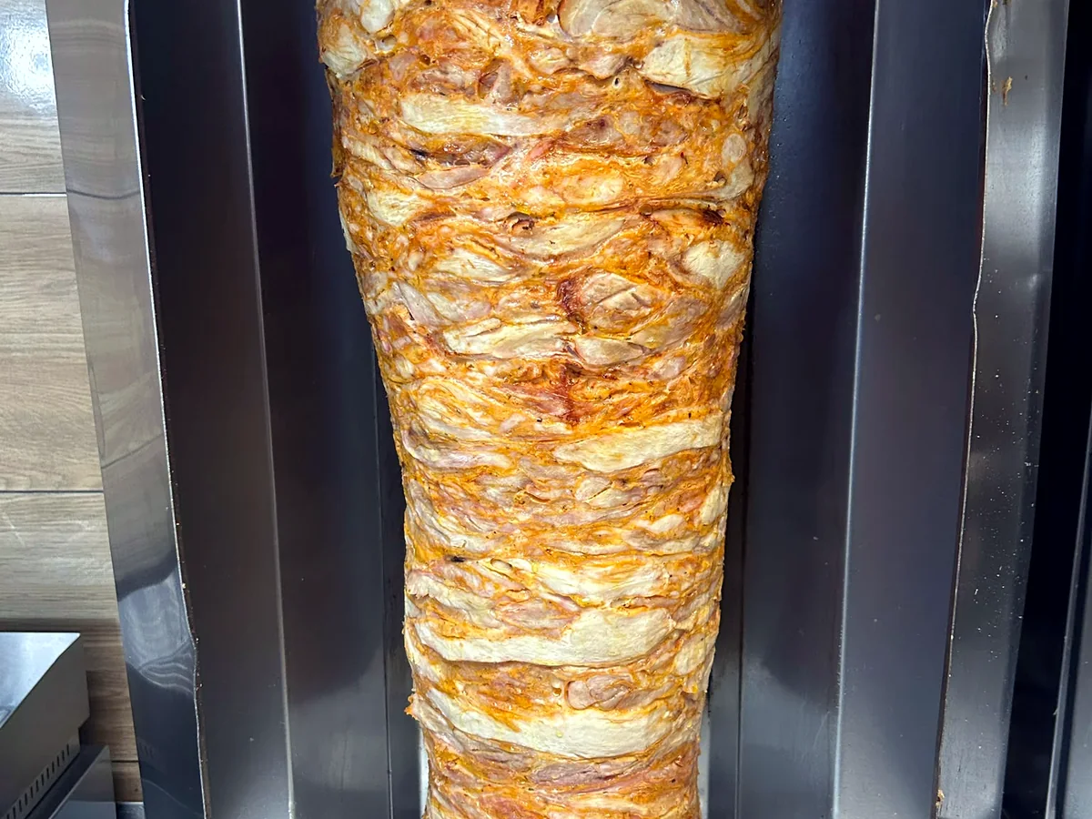 Light layers of meat on a vertical spit