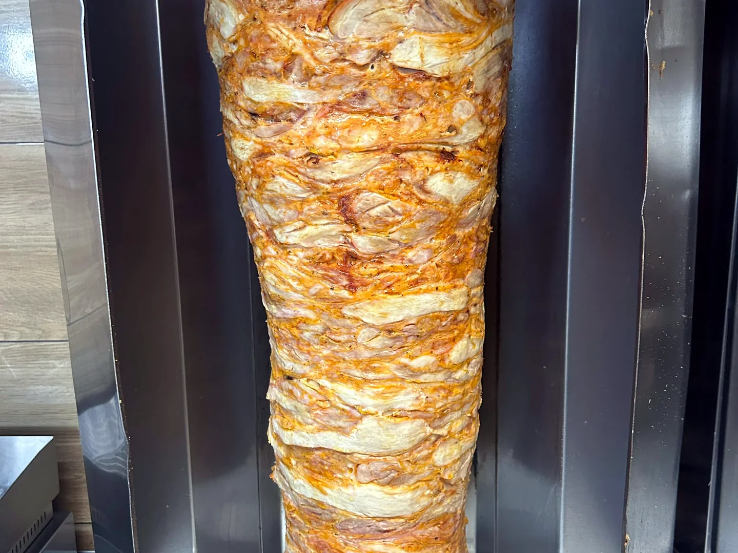 Meat on a vertical spit in a kebab grill